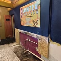 The old LanTex sign propped against a painted lobby wall